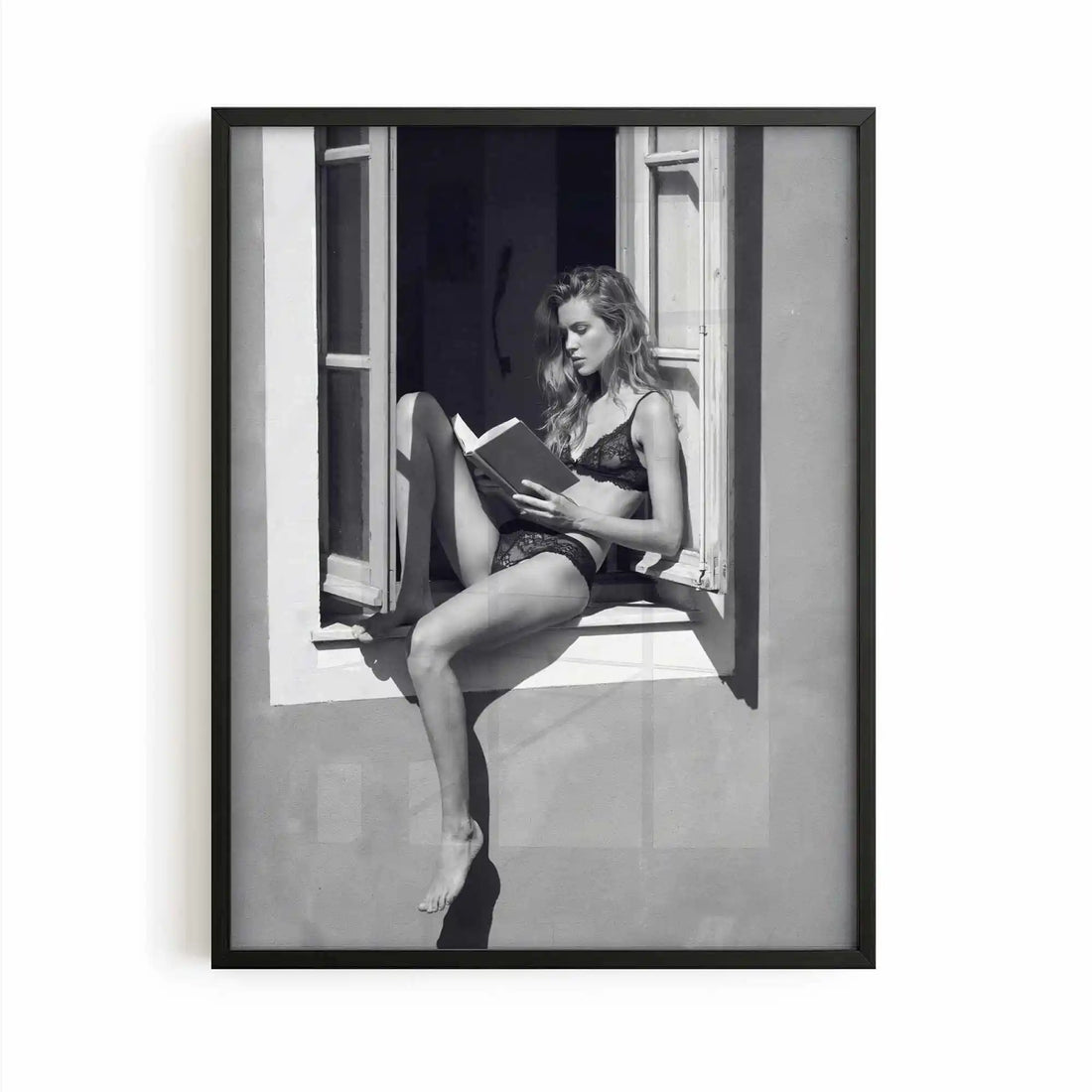 black framed poster print featuring a girl reading a book at a french window artwork with monochrome tones and luxury French New Wave vibe. by AfterHours Gallery