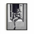 black framed poster print featuring a girl reading a book at a french window artwork with monochrome tones and luxury French New Wave vibe. by AfterHours Gallery