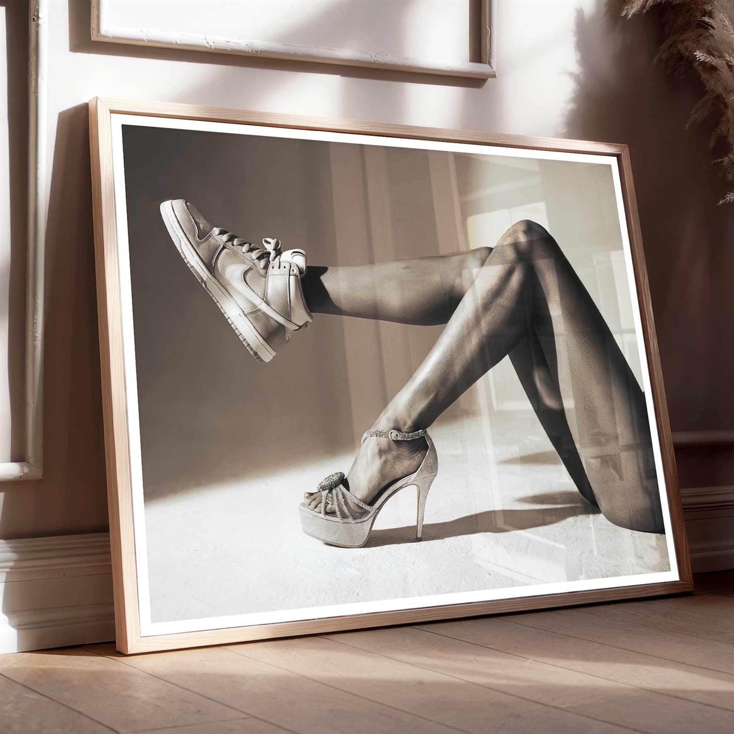Framed black and white photo of a person wearing high heels and stockings.