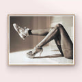 Framed black and white art print of a woman's legs in tights and high heels.
