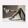Black and white high fashion poster featuring high heels and sneakers.