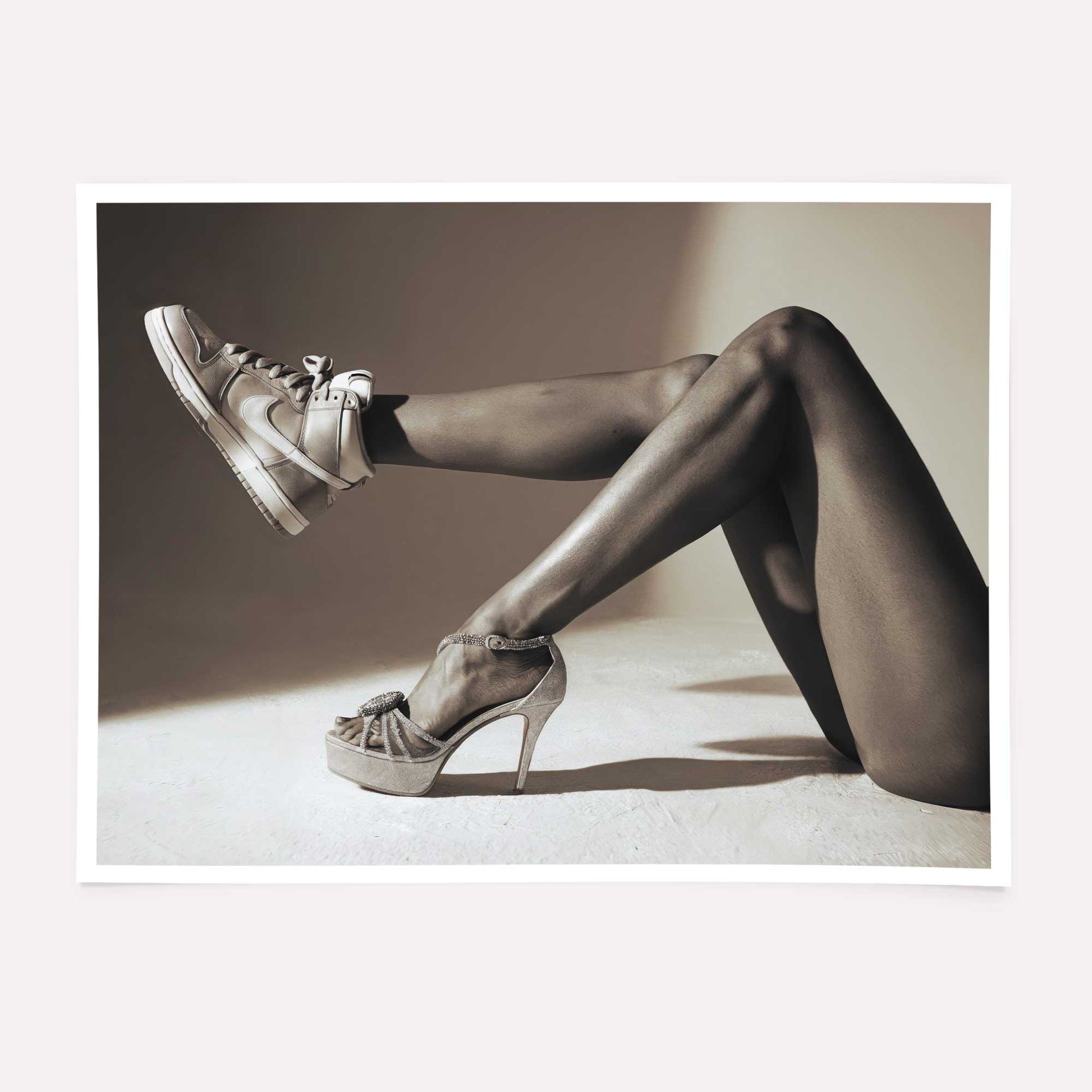 Black and white high fashion poster featuring high heels and sneakers.