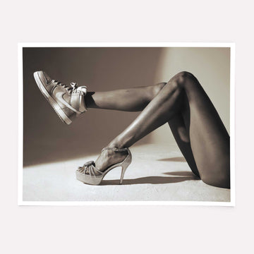 Black and white high fashion poster featuring high heels and sneakers.