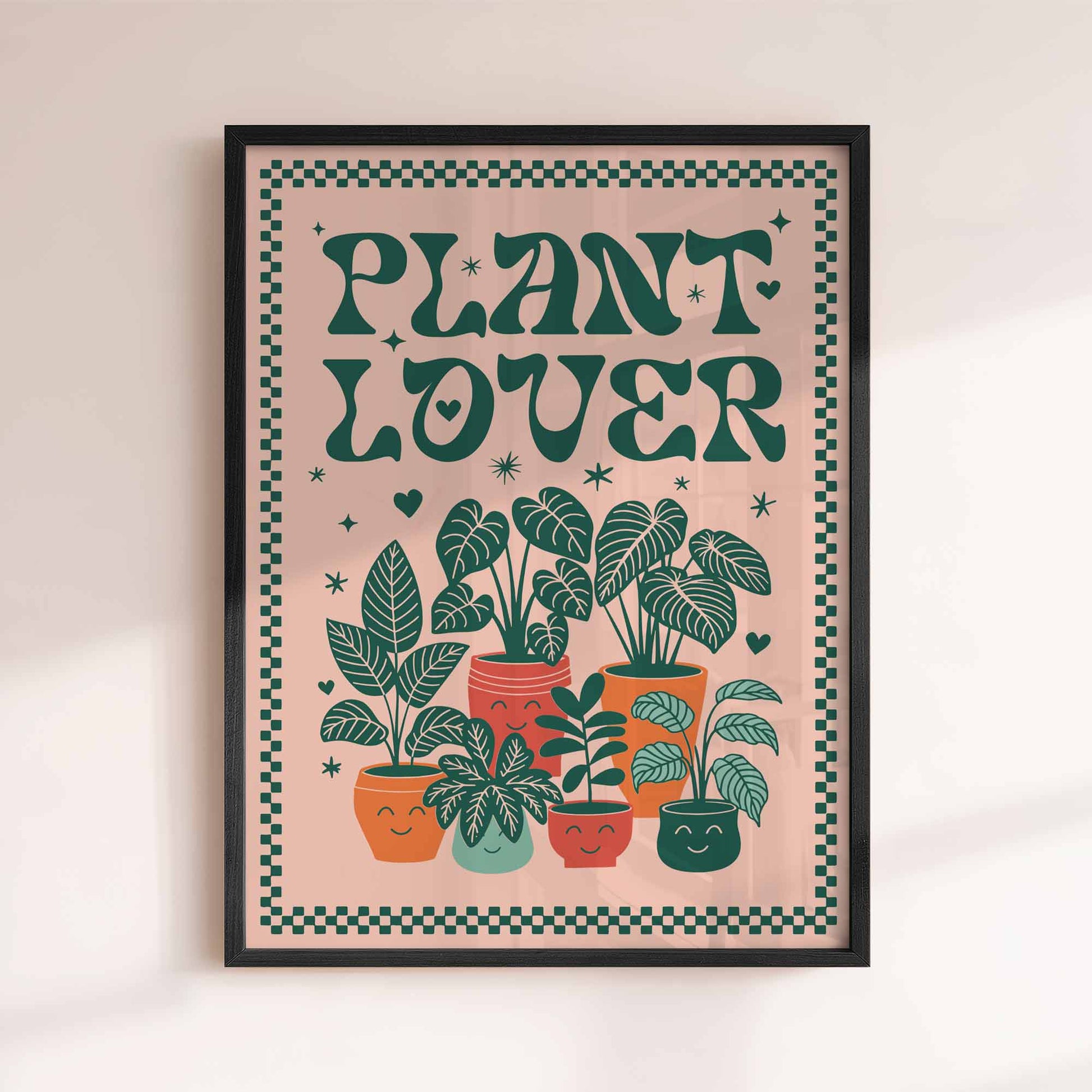 Framed poster with 'Plant Lover' text and illustrations of potted plants on a beige background. afterhours gallery