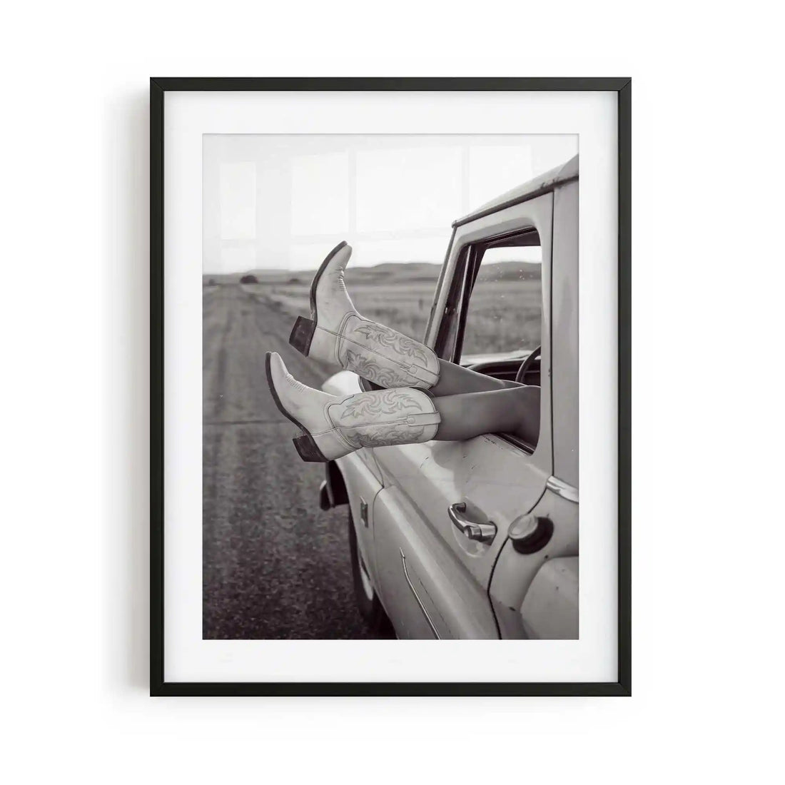Road Trip is a western photography framed print featuring cowgirl boots and a vintage truck. Rustic Americana wall art for country, ranch and modern western interiors.