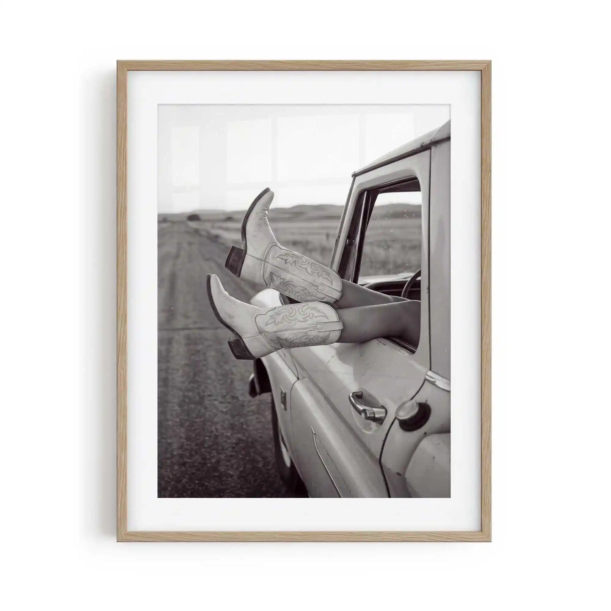 Road Trip is a western photography framed print featuring cowgirl boots and a vintage truck. Rustic Americana wall art for country, ranch and modern western interiors.