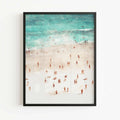 Coastal wall art print featuring an overhead beach scene with tiny people framed in black frame by Afterhours Gallery
