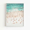 Coastal wall art print featuring an overhead beach scene with tiny people framed in white frame by Afterhours Gallery