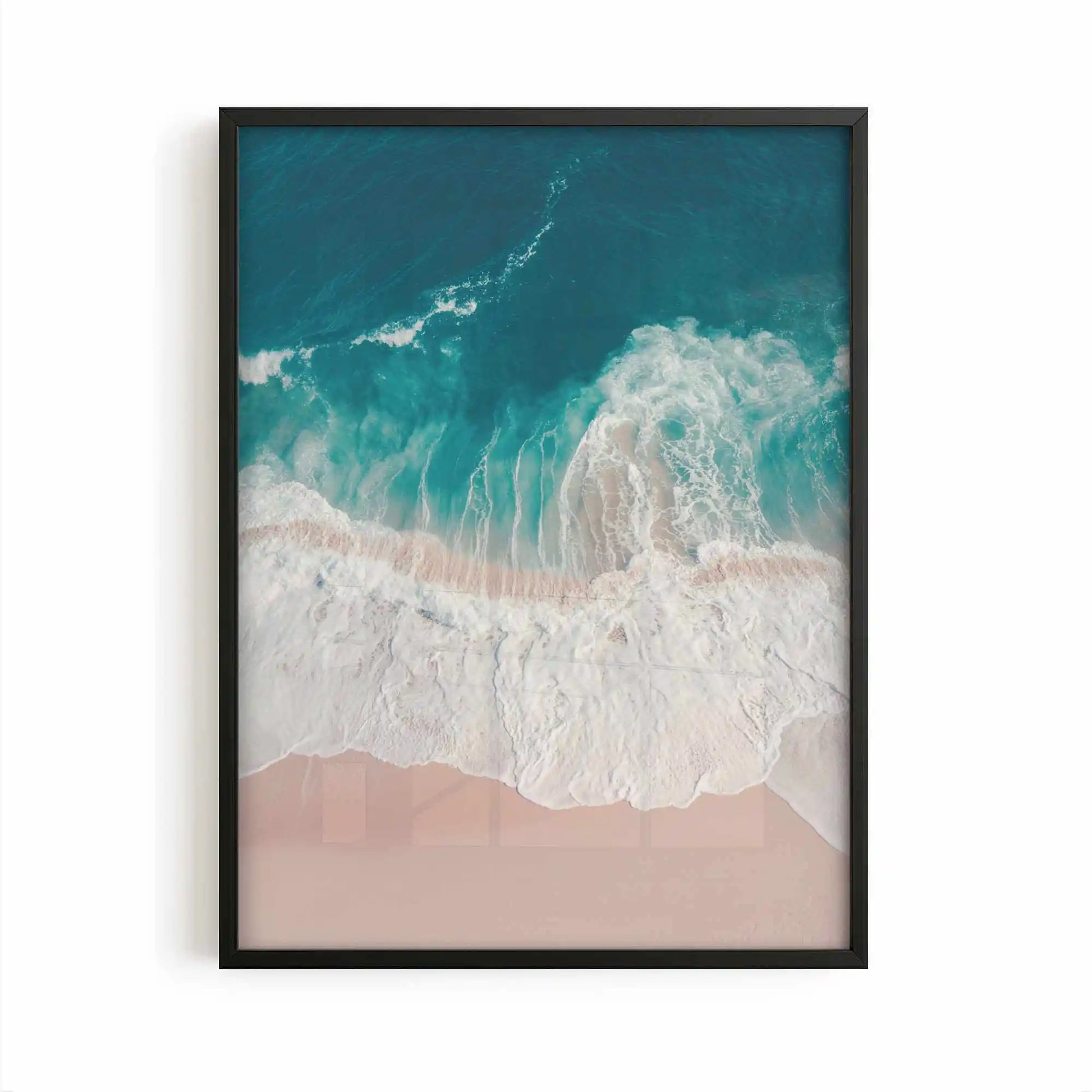Aerial beach photography print showing turquoise ocean waves washing onto soft sandy shores in a calming coastal scene.