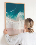 Aerial beach photography print featuring turquoise ocean waves and soft sandy shores. Coastal wall art inspired by endless summer living.