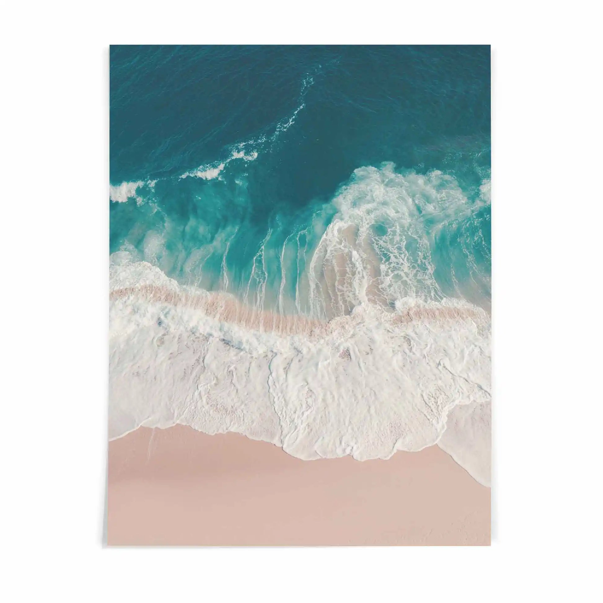 Aerial beach photography print showing turquoise ocean waves washing onto soft sandy shores in a calming coastal scene.