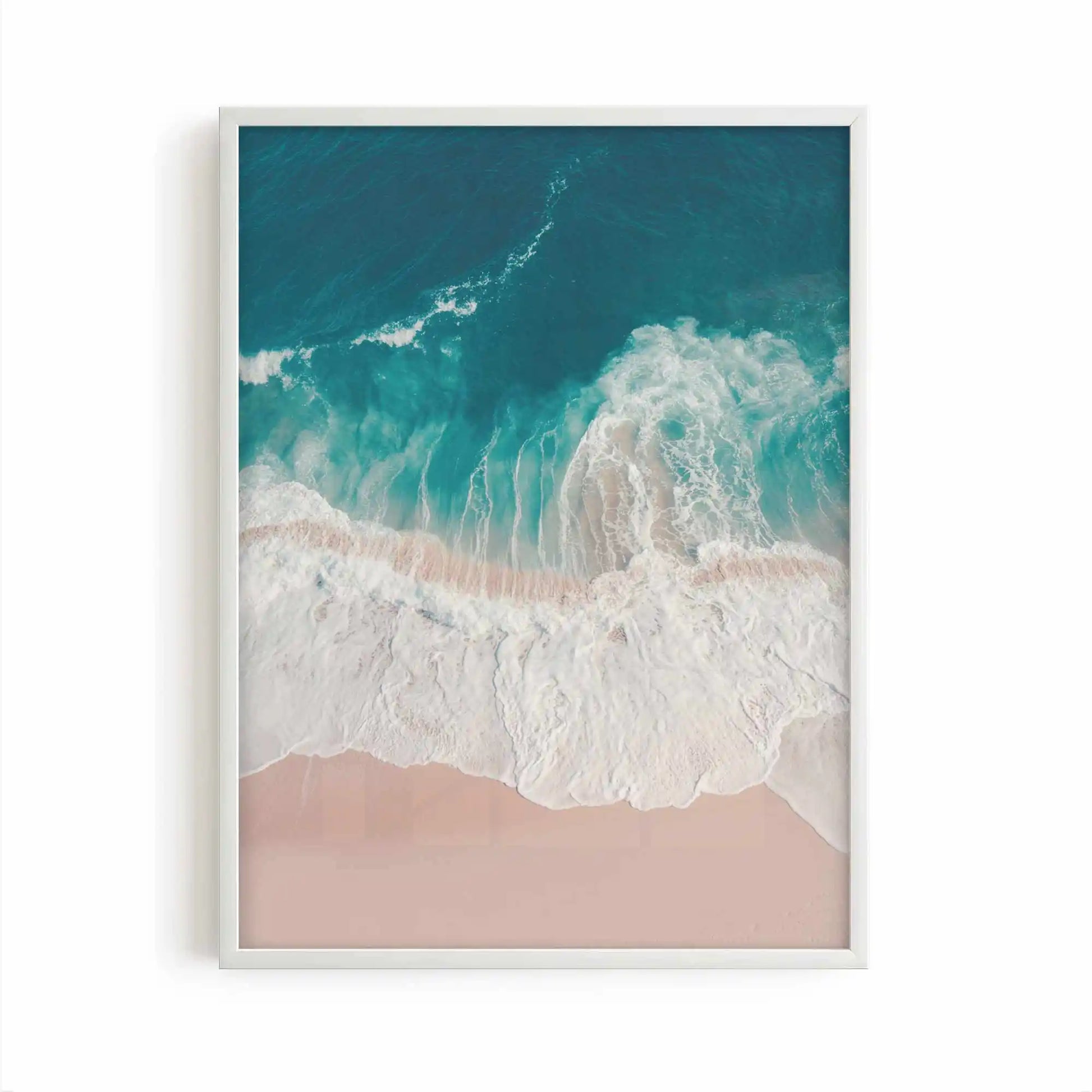 Aerial beach photography print showing turquoise ocean waves washing onto soft sandy shores in a calming coastal scene.