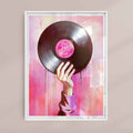 Framed artwork of a hand holding a vinyl record with a pink label against a colorful abstract background.