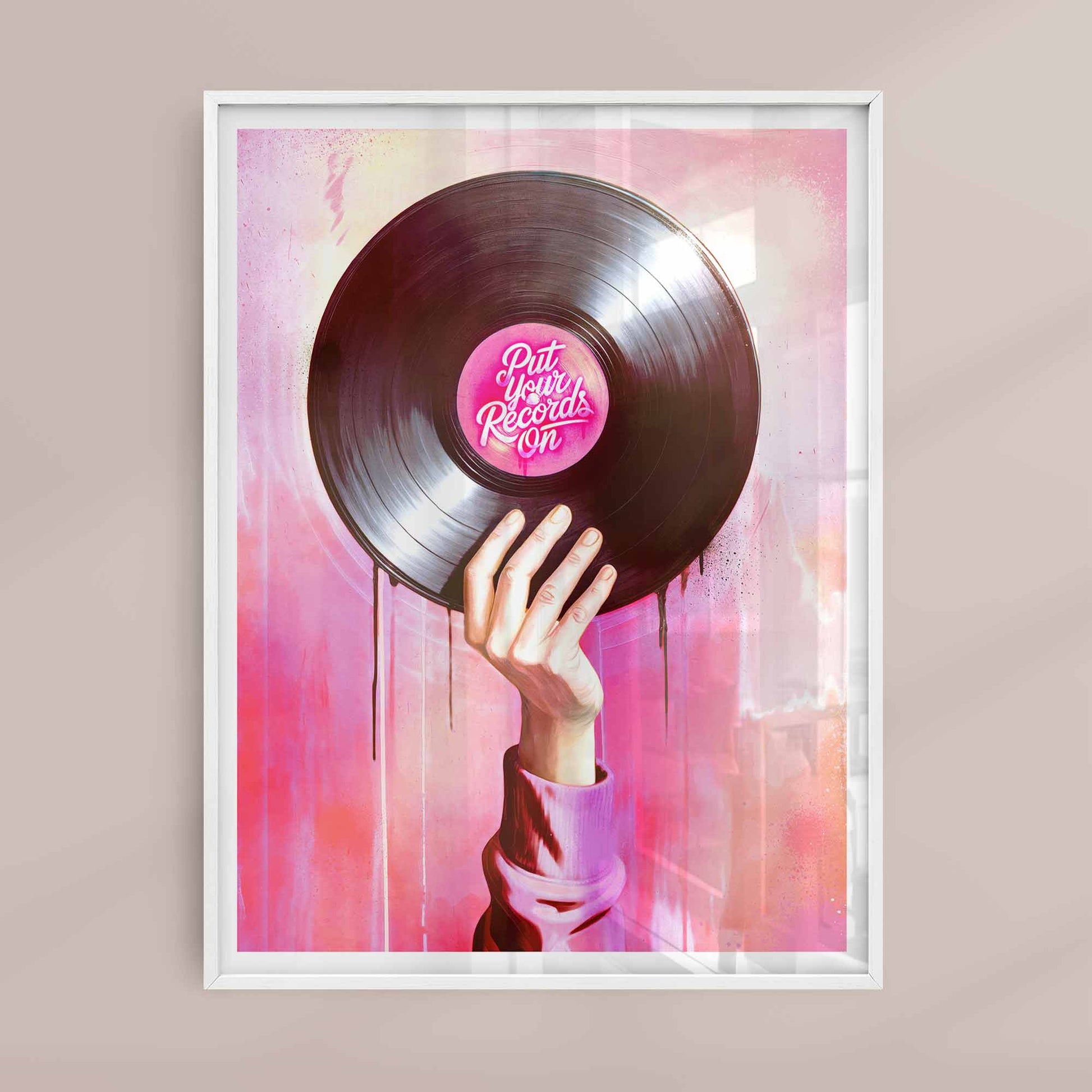 Framed artwork of a hand holding a vinyl record with a pink label against a colorful abstract background.