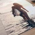 Surfer girl walking into the ocean at golden hour carrying a surfboard during sunset, creating a peaceful coastal photography  poster detail