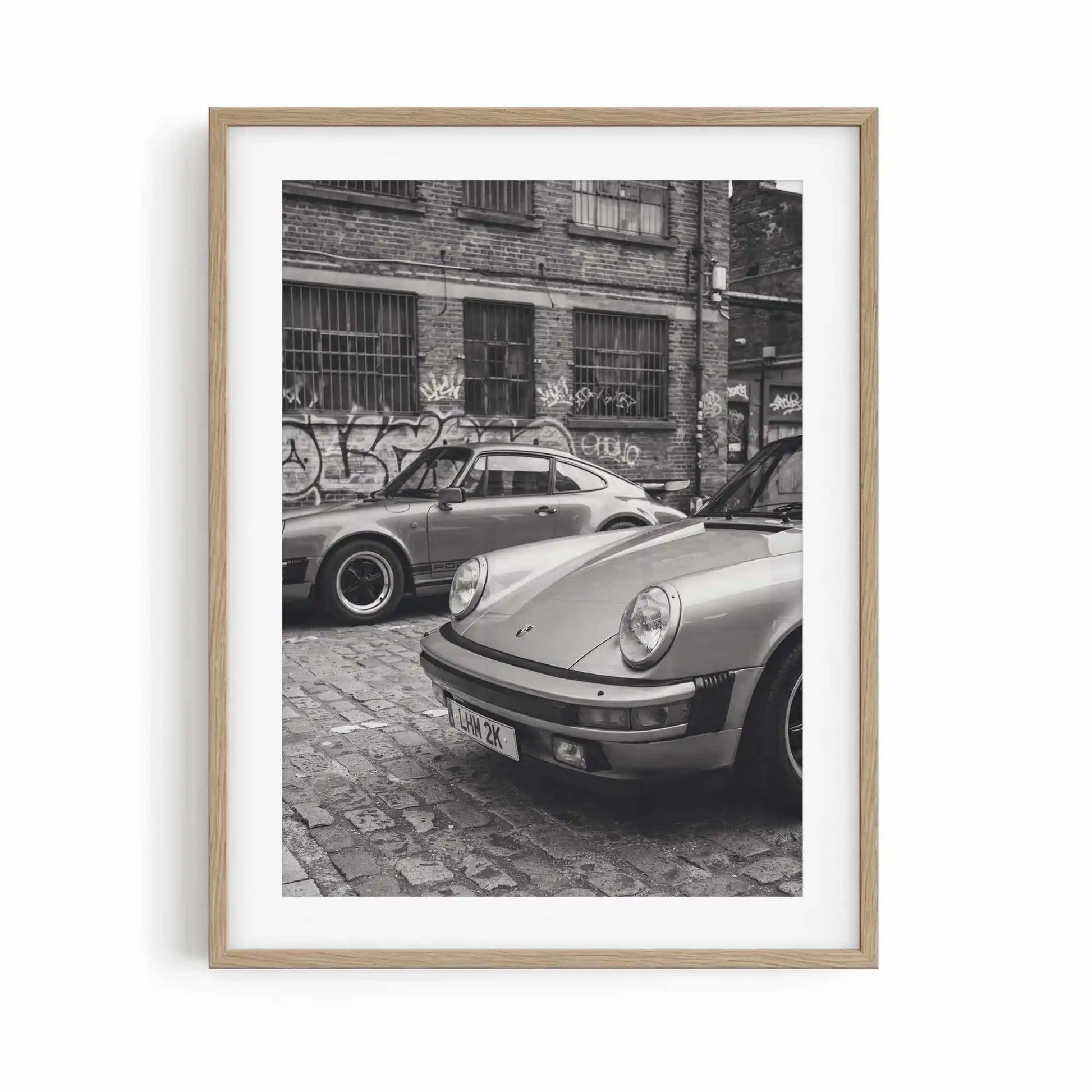 Nine Eleven classic Porsche wall art displayed in a natural oak frame for modern interiors.