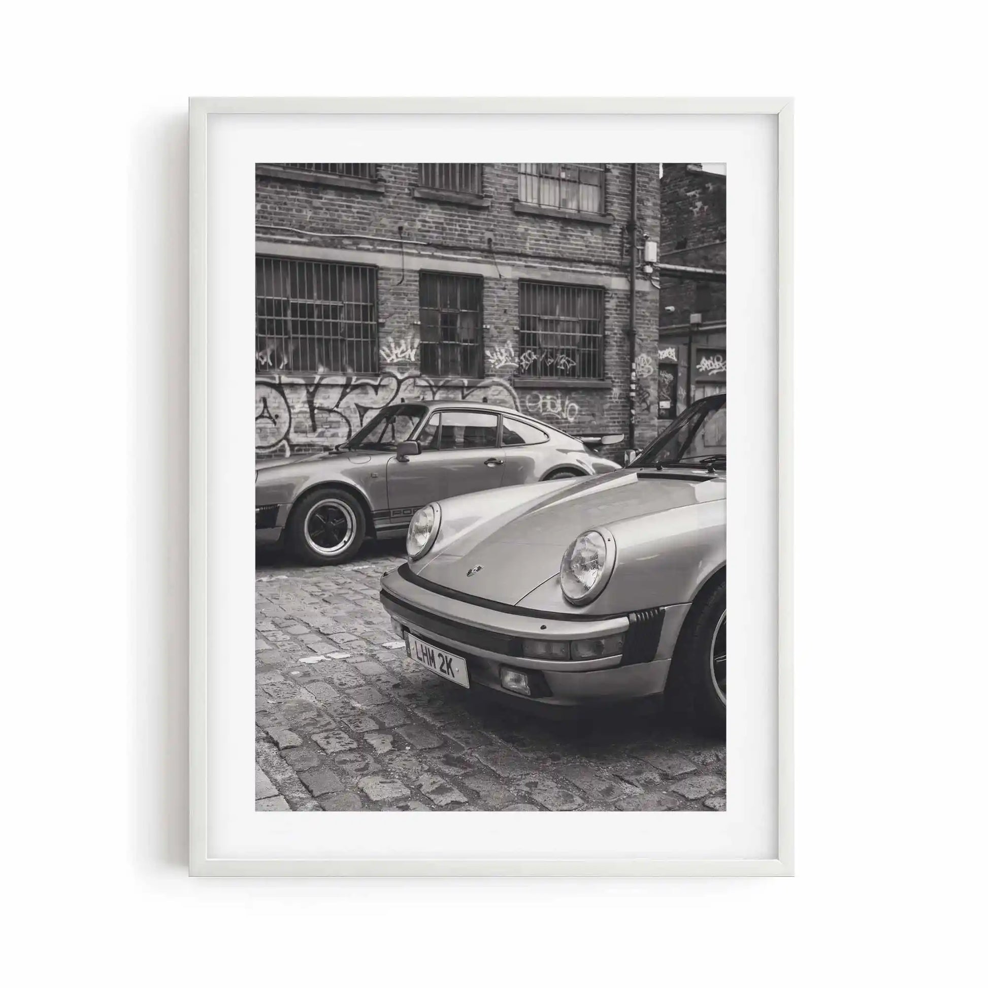 Nine Eleven monochrome Porsche wall art displayed in a white gallery frame.