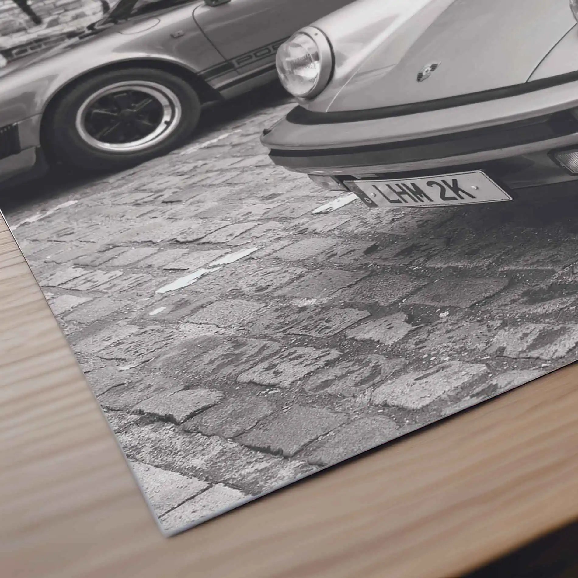 Close-up detail of Nine Eleven Porsche 911 monochrome automotive photography print showing iconic headlights and bodywork.