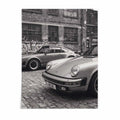 Nine Eleven Porsche 911 black and white wall art by After Hours Gallery featuring two classic sports cars in an industrial urban setting.